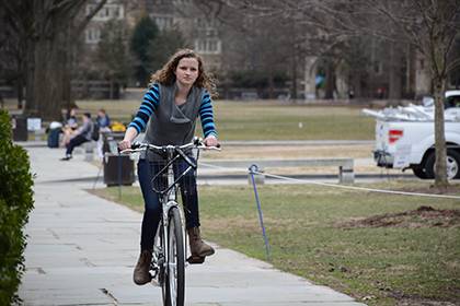 Susan Jennings rides on a rented Zagster bike on West Campus. All Duke community members can sign up for the bike-share program, which has bike racks on East, Central and West campuses. Photo by Bryan Roth.