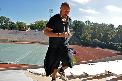 Tevante Clark, a Duke employee depdendent, runs steps at Wallace Wade Stadium. With help from Duke health management programs, he's lost over 200 pounds in the past two years. Photo by Bryan Roth.