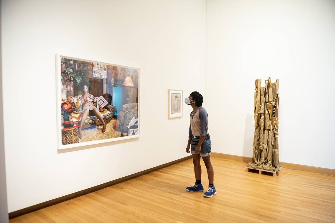 A visitor takes in Lovely Six Footaby Mickalene Thomas. Photo by J Caldwell.