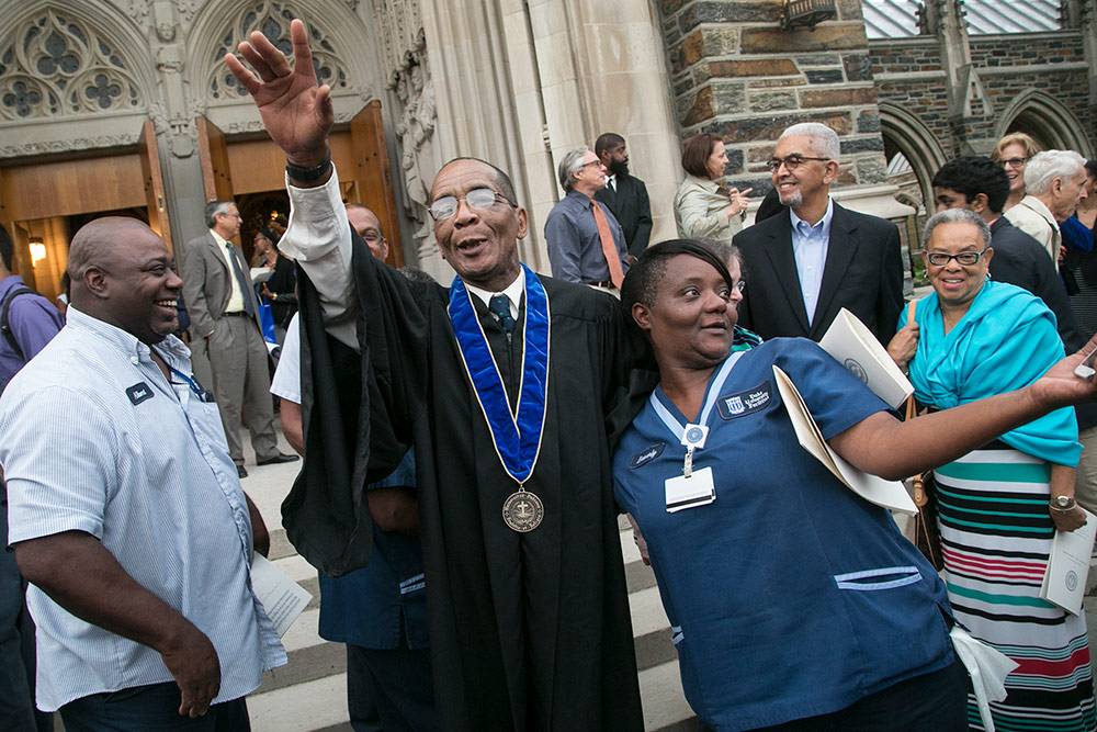 Oscar Dantzler poses for photos with friends and coworkers following the Founders' Day ceremony. Photo by Chris Hildreth/Duke Photography