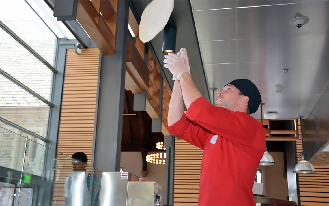 Kyle Rosch, director of operations for Duke Dining’s Il Forno in the West Union, tosses dough. Photo by Beth Hatcher.