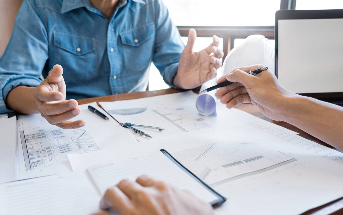 People talking at a desk.