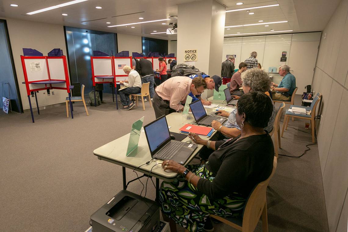 Voters receive ballots at the early voting site in the Brodhead Center. Photo by Megan Mendenhall