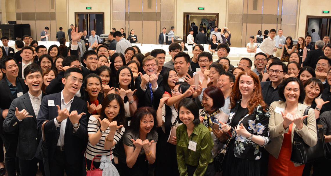 Duke President Vincent Price expresses his Bull City Pride with students and alumni in Shanghai.