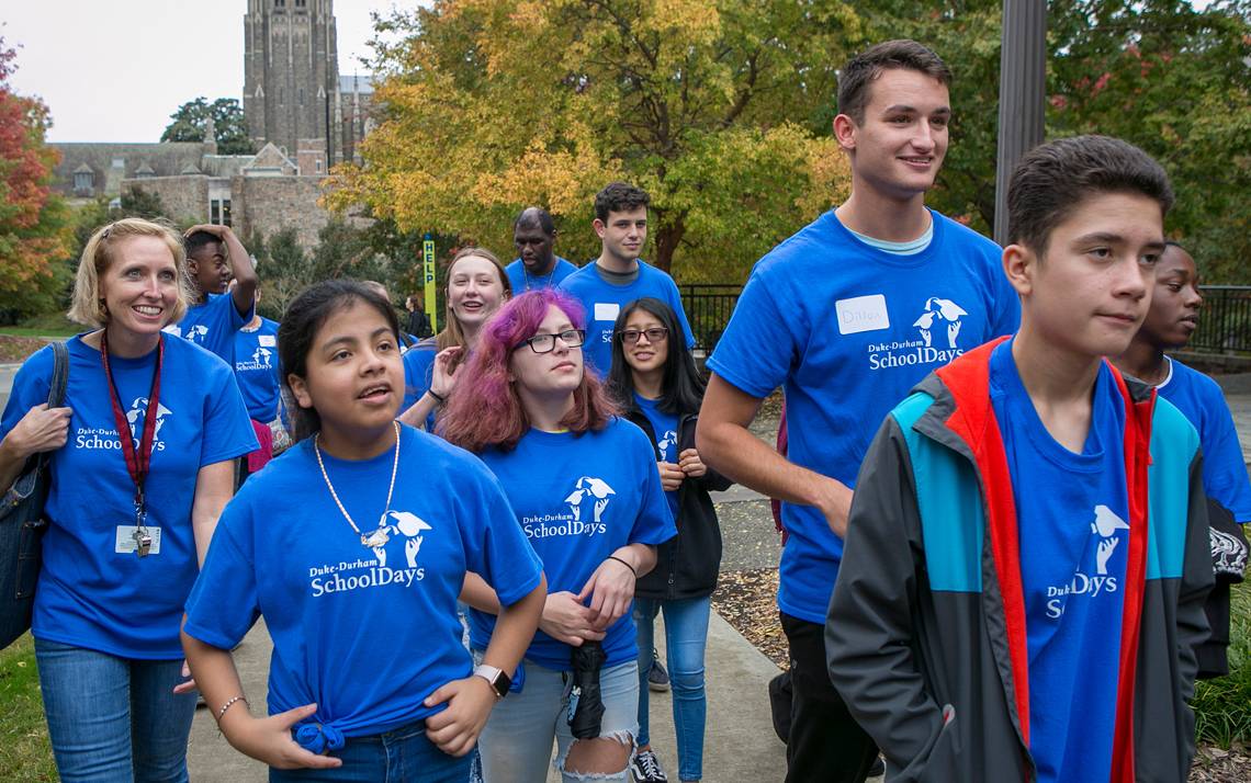 Duke senior Dillon Leovic, right, takes an eighth grade classroom from Little River K-8 on a tour of campus during Duke-Durham School Days. Photo by Jared Lazarus.