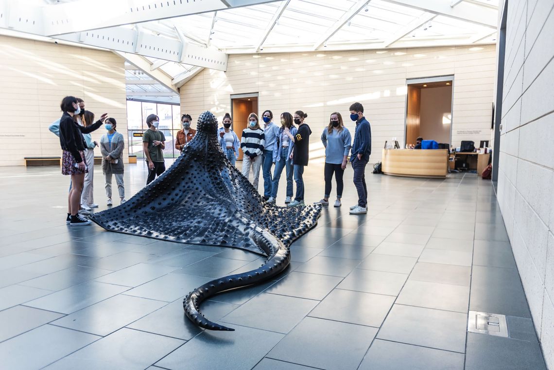 Visitors lean in for a close look at “MamaRay,” a new bronze sculpture by Wangechi Mutu at the Nasher Museum of Art. (Photo by J Caldwell)