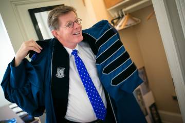 Vince Price gets his robe ready in advance of the inauguration. Photo by Duke Photography