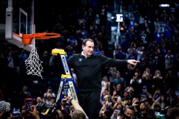 Coach K cuts down the nets after winning the regional