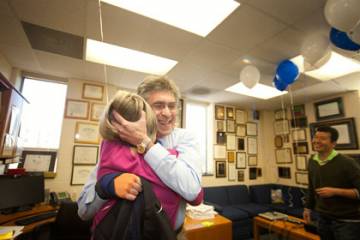 Upon arriving in his office Wednesday, Robert Lefkowitz hugs his administrator of 35 years, Donna Addison. Photo by Jared Lazarus/Duke University Photography