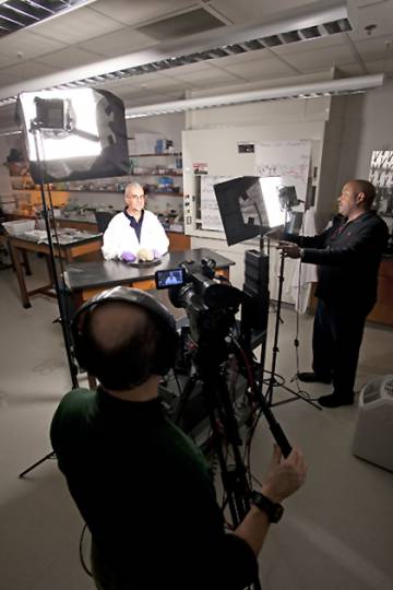 Leonard White, associate professor in the Duke Institute for Brain Sciences, films a lecture for his Medical Neuroscience class, available through Coursera. Behind the camera is Kennard Blake, videographer/editor for University Center Activities & Events