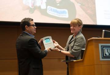 Conference keynote speaker Chuck Slaughter, left, received the Enterprising Social Innovation Award from Erin Worsham, executive director of Fuqua’s Center for the Advancement of Social Entrepreneurship. Slaughter is the founder and president of Living