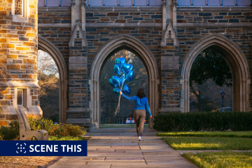 Duke Senior Ana Markey walks on West Campus with Duke Blue Valentine's heart-shaped balloons.