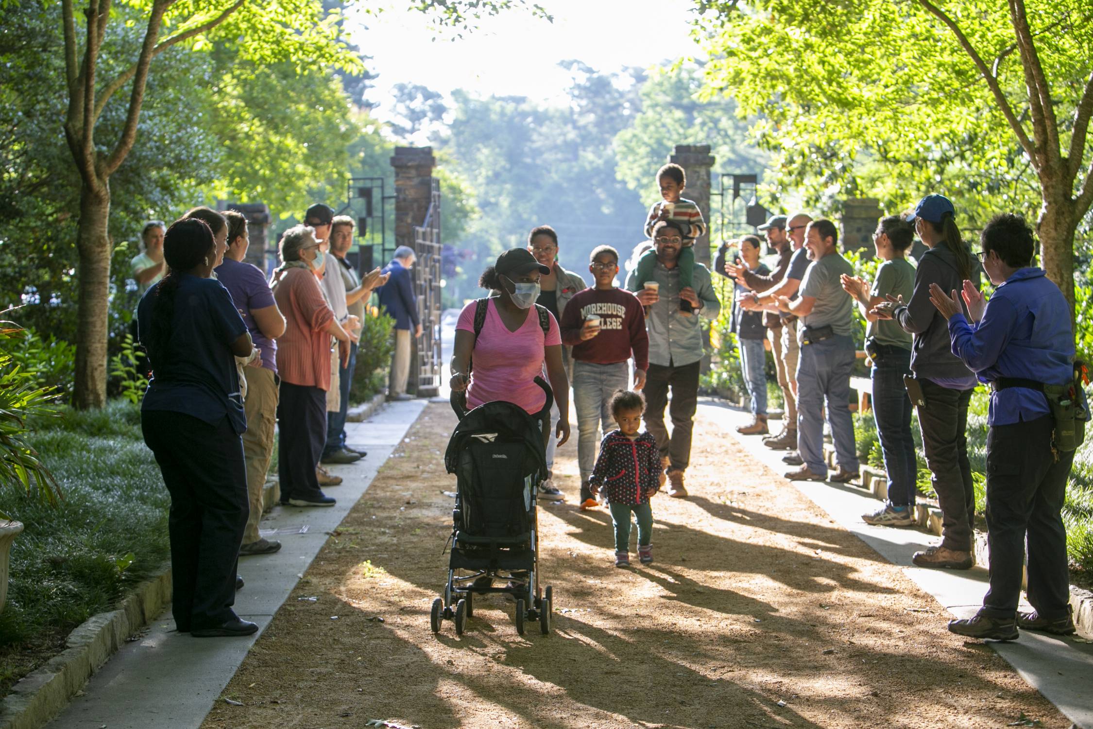 Lined by applauding staff, the first visitors enter through the front gate of Sarah P. Duke Gardens at 8am on Tuesday June 1, 2021.