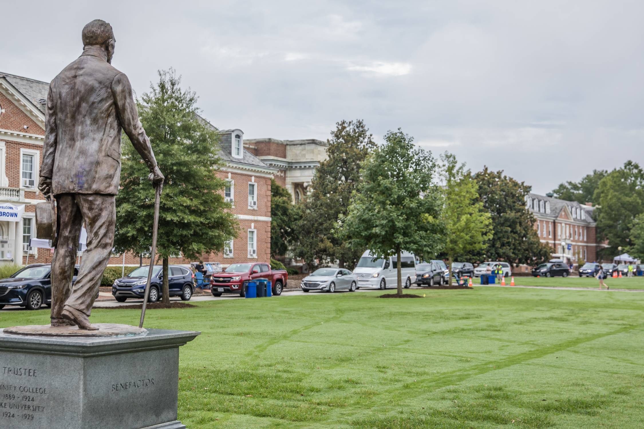 The statue of Benjamin Duke overlooks a line of cars ready for move in day 2021. (Kyle Fox)
