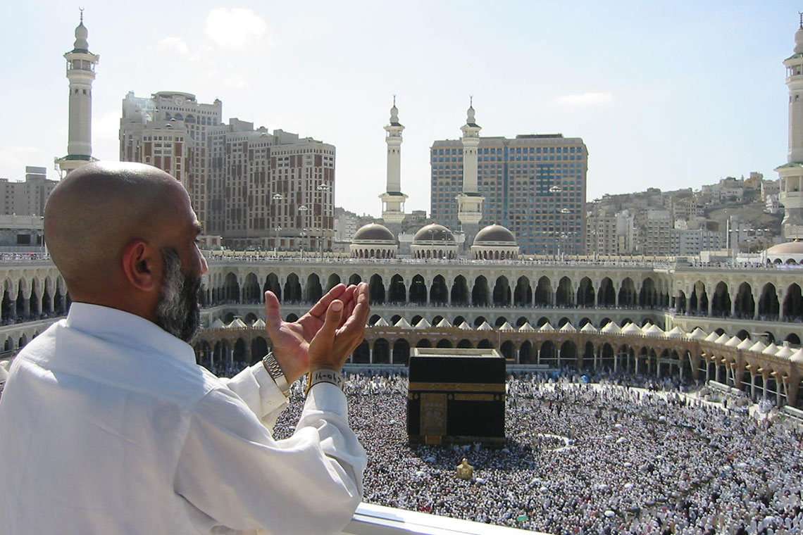 A pilgrim raises his hands in prayer