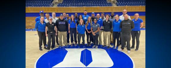 The team members in Athletic Facilities, Game Operations, Championships and Events pause for a photo before the Duke-UNC basketball game in 2022. Photo courtesy of Becca Wilusz.