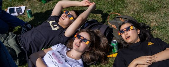 students on West Quad watch the eclipse