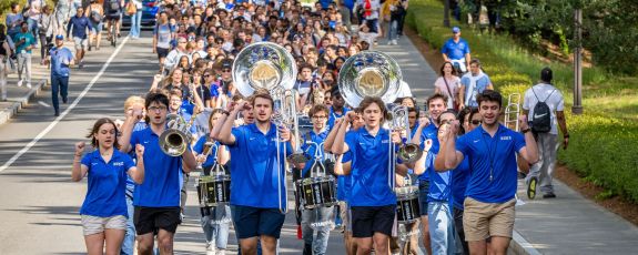Members of the Duke Marching Band lead first-year students down Chapel Drive during the Bricks to Stone event. Photo by Bill Snead