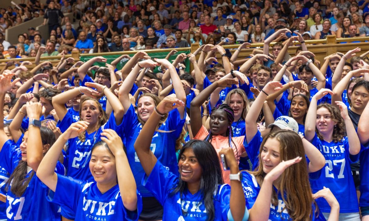 Students in blue Duke jerseys fill the stands in Cameron Indoor Stadium and practice some important cheers