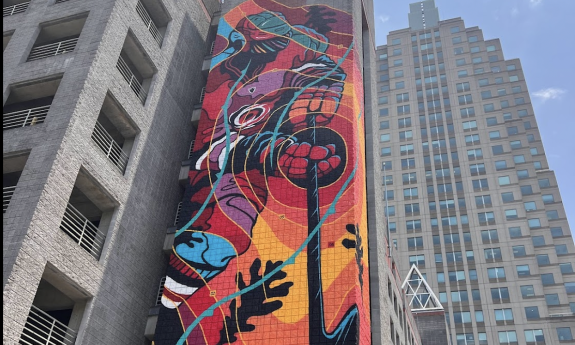 A colorful mural on the side of a building in downtown Raleigh