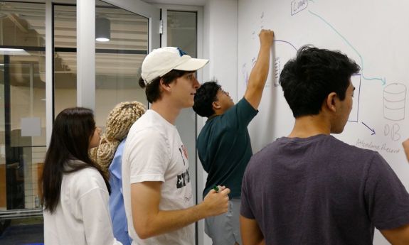 Code+ students work on a coding project.