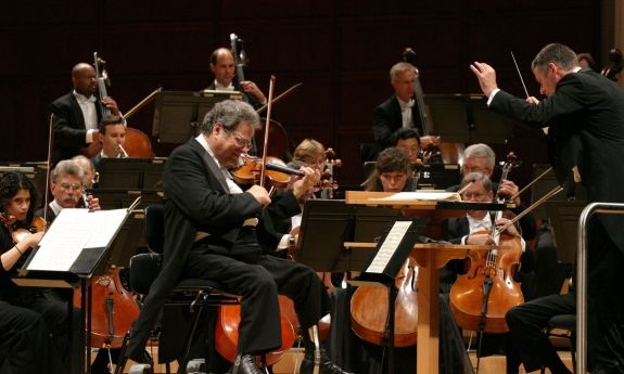 The NC Symphony peforms with Itzhak Perlman in 2008. Duke arts vice provost John Brown is on the bass in the left back row.