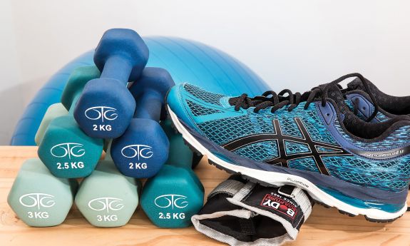 hand weights, a running shoe and other fitness equipment