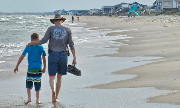 Steven Earp, right, walks on the beach with his grandson, William. Photo courtesy of Steven Earp.