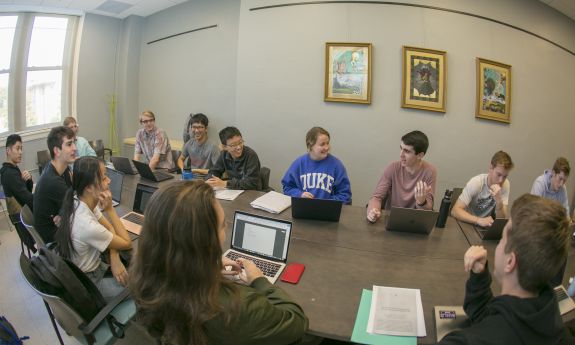 Students smiling and talking in a classroom