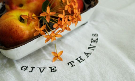 fall flowers and fruits on a white tablecloth.