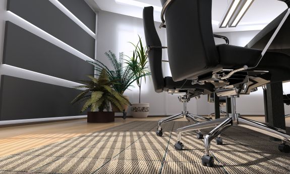 An empty office setting features two rolling chairs