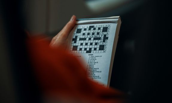 A person doing a crossword puzzle