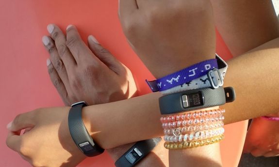 Kids showing Garmin bracelets on their arms