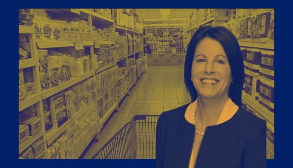 Alison Taylor super imposed on a supermarket aisle using Duke Climate Commitment stylized branding