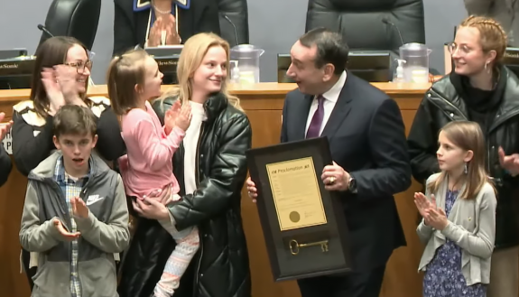 Former Coach Mike Krzyzewski talks with family members after receiving the key to the city of Durham