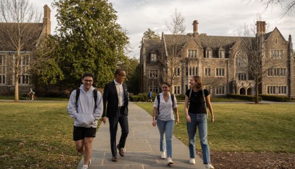 Gary Bennett walking on campus with students