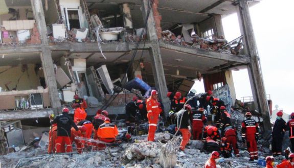 rescue workers at collapsed building in Turkey