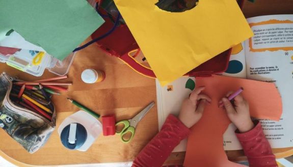 overhead view of child creating collages