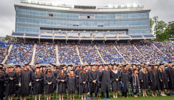 Students standing during the 2022 Commencement ceremony in Wallace Wade Stadium.