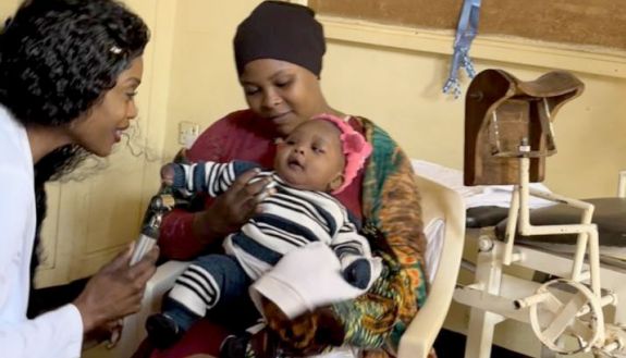 nursing student in Tanzania with mother and young child