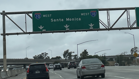 A highway sign pointing to Santa Monica, California