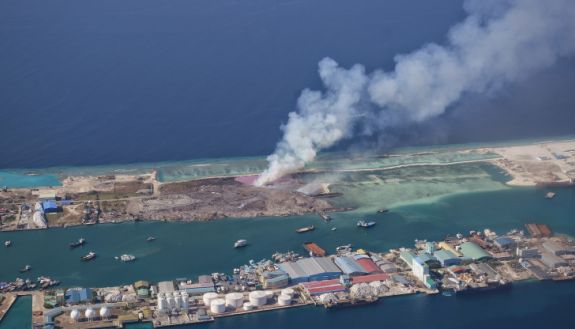 aerial photo of trash burning in the Maldives