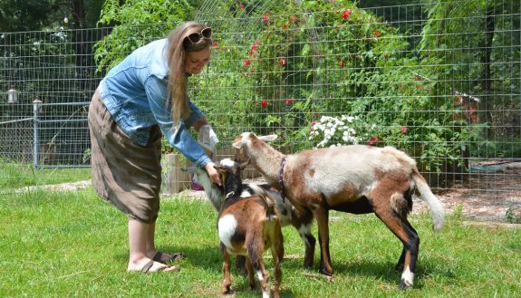 Kate Plyler feeding her goats.
