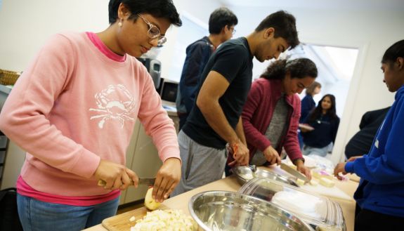 Anushka Goel, prepping potatoes during a hands-on Hindi cooking module, feels studying a language is less about learning the mechanics and more about discovering a new way of seeing the world. (John West/Trinity Communications)