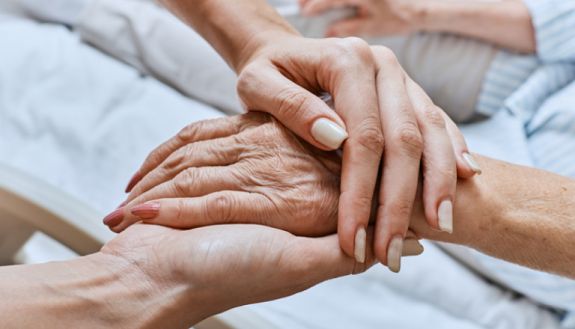 stock image of hand holding with elderly patient