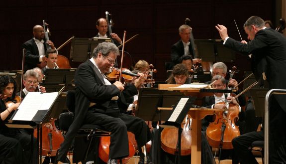 The NC Symphony peforms with Itzhak Perlman in 2008. Duke arts vice provost John Brown is on the bass in the left back row.