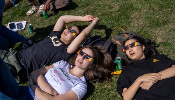 students on West Quad watch the eclipse