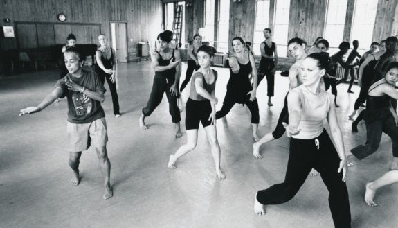 1997 black and white image of instructor (Carolyn Adams) working with dance students
