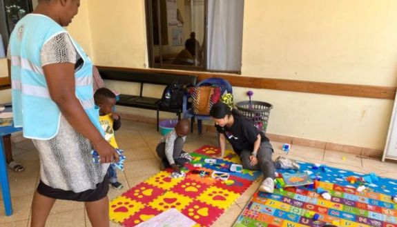 Sydney Chen, fourth from left, plays with a child at the Jaliwatoto Childcare Centre at Lumumba Sub-County Hospital in Kisumu, Kenya.