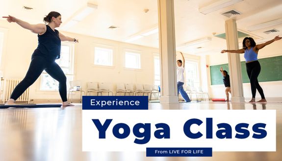 Yoga teacher leading a class in a well lit room.